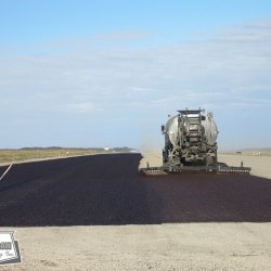 Fog coating a runway after chip seal helps retain the aggregate in place