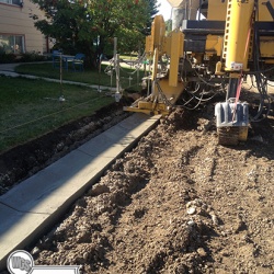 Placing curb in subdivision using concrete extruder