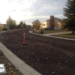 New curbs, gutters, sewer, water, and gravel prior to asphalt placement