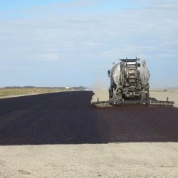 In this picture West-Can is fog coating a washed chip seal project on a private runway to help retain the aggregate in place