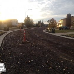 A road building project, prime coated and ready to be paved