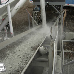 Blending dry bulk cement into custom pug mill mix