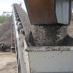 Once the product is mixed, it is then discharged onto a stacking conveyor to be stockpiled